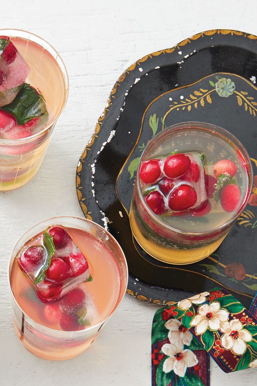 a glass of white grape punch with cranberry ice