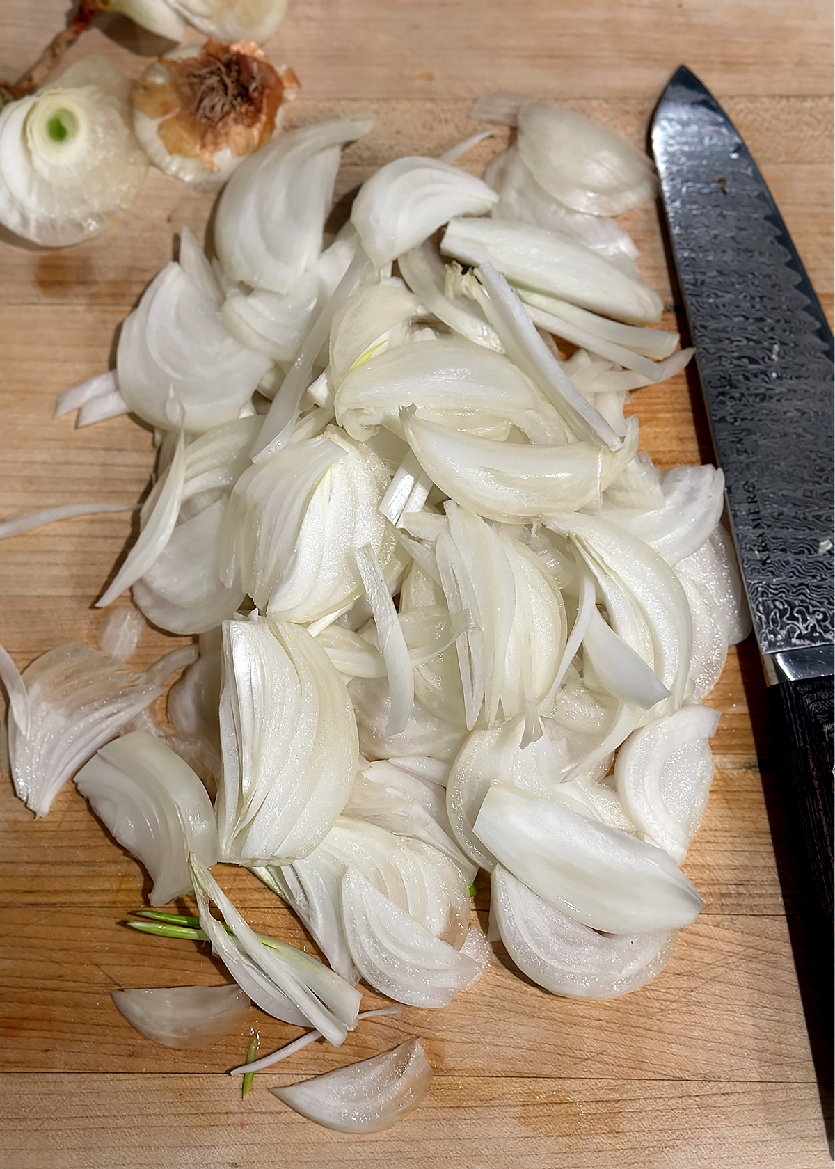 sliced onions on cutting board