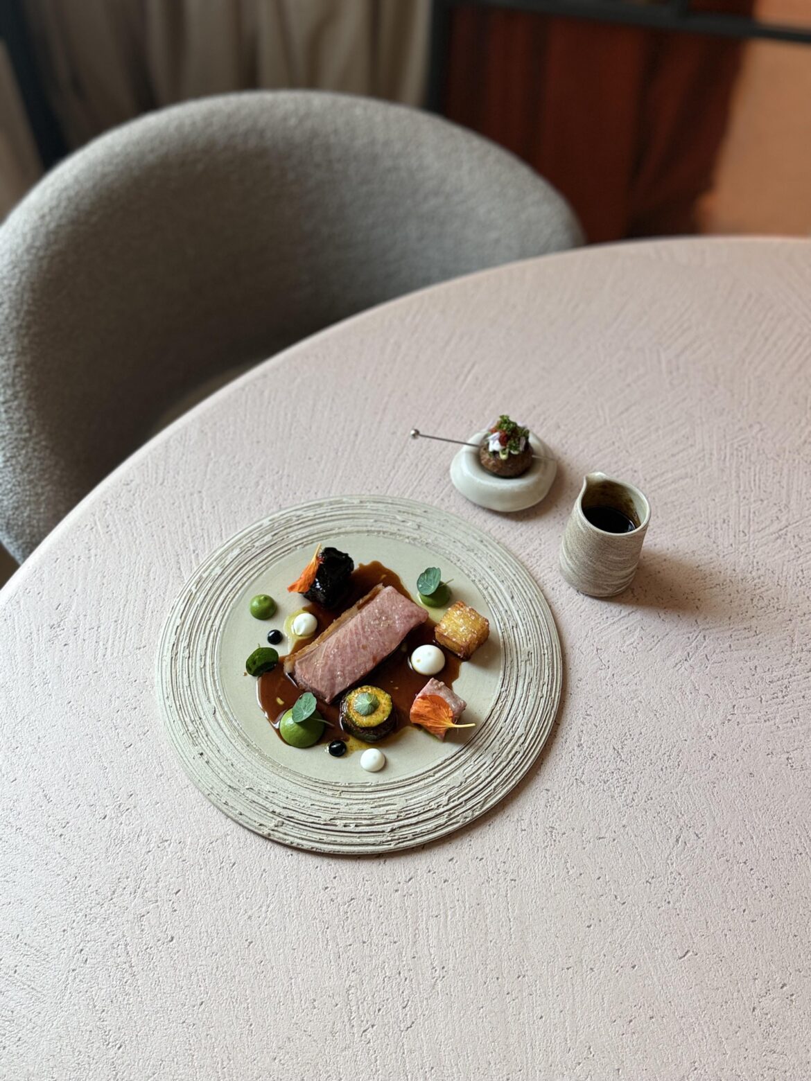 Lozère lamb saddle (roasted on the carcass), zucchini, harissa, potato terrine, yoghurt & black garlic.                                                   On the side bbq köfte with ramsons, bell pepper