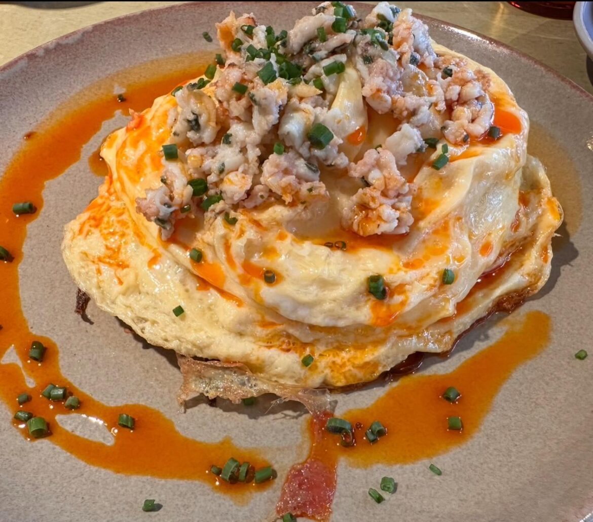 Creamy omelette topped with chili oil and shrimp mince