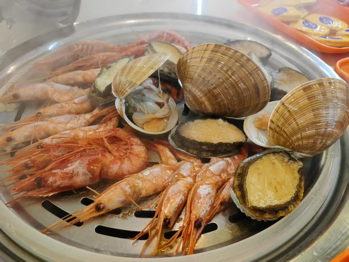 Steamed seafood platter including prawns , clams and abalone fresh off the grill