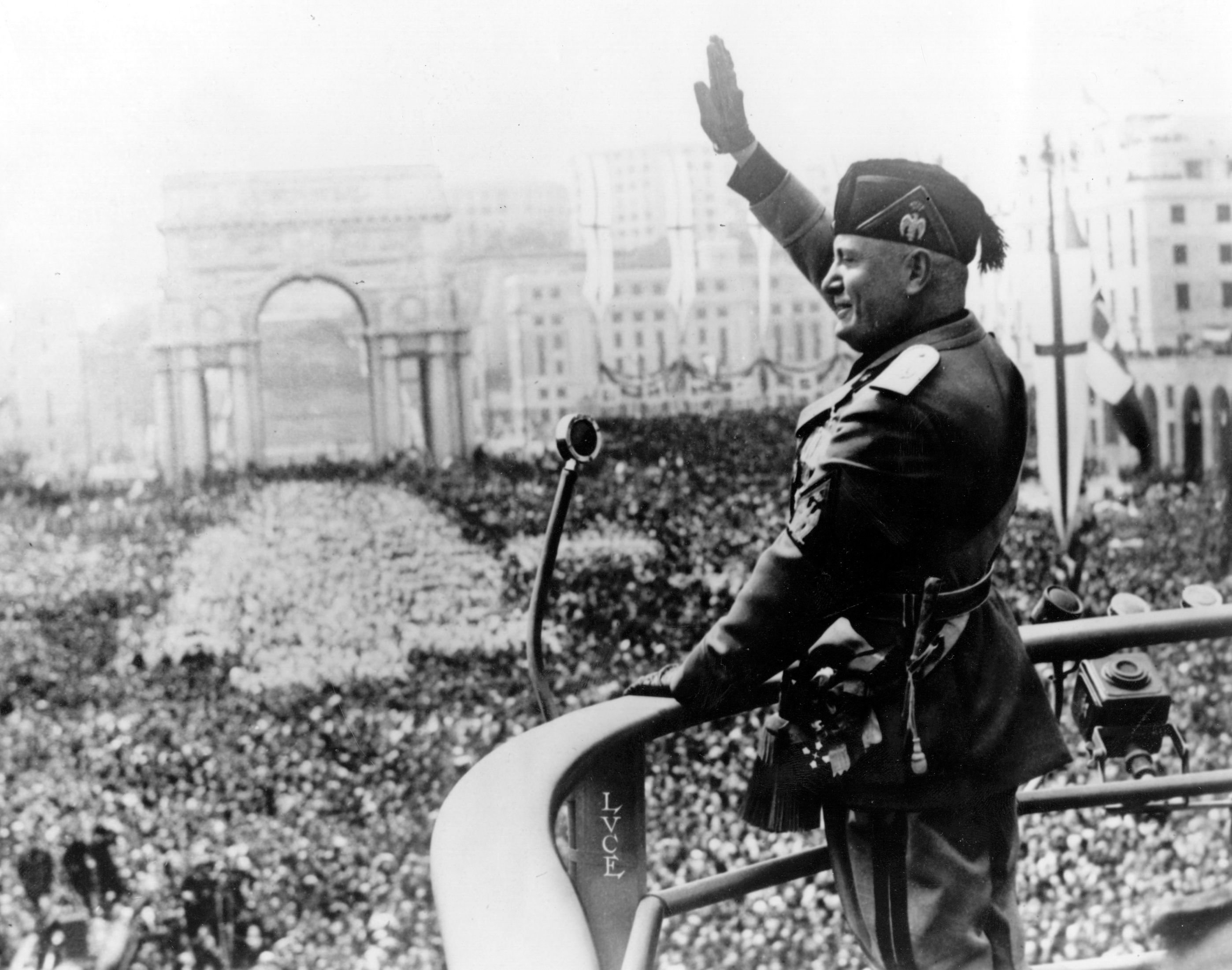 Benito Mussolini saluting a large crowd.