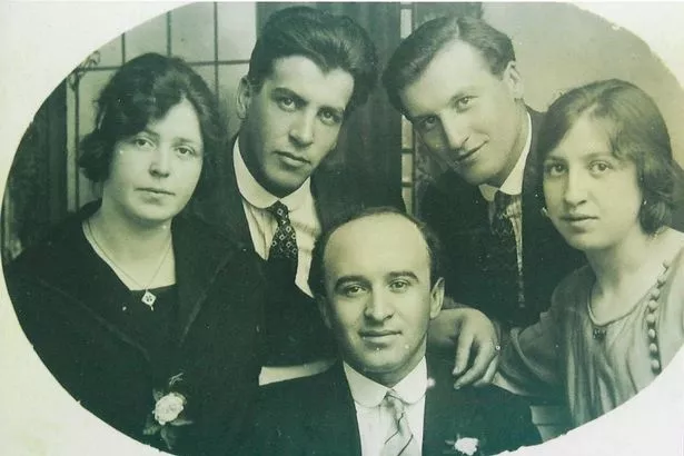 Attilio (middle) and his family pose for a portrait