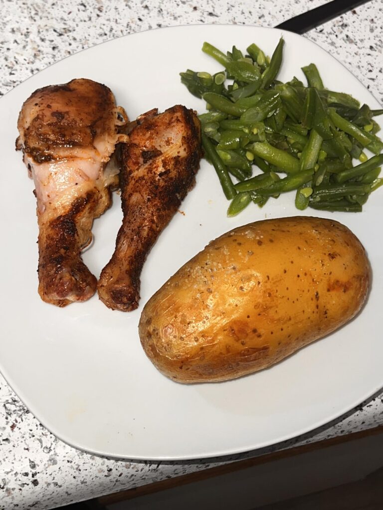 Chicken leg with baked potato and green beans