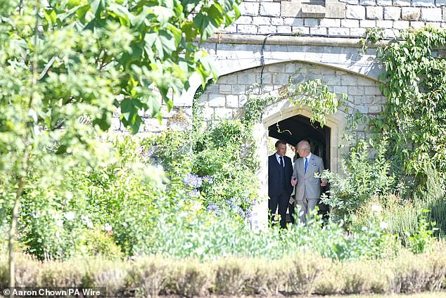 A private period of the visit saw Mr and Mrs Macron lay flowers at the tomb of Queen Elizabeth II (pictured: Mr Macron and the King in the South Gardens)