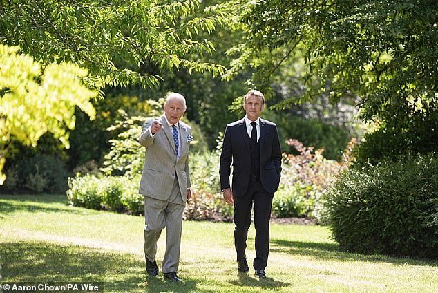 The King appeared animated in conversation as he conducted the personal tour of the gardens with Mr Macron - thought to be a State Visit first