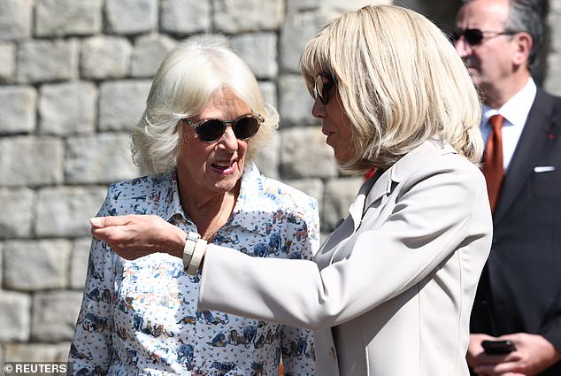 The pattern, depicting a menagerie of animals, was inspired by the artwork of Brian Wildsmith (pictured: the Queen with Mrs Macron in the gardens of Windsor Castle)
