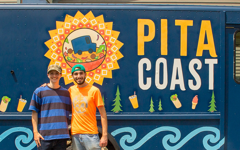 Shea Turner-Matthews '26, left, and Mustafa Khorzom '25 with Pita Coast, their pop-up restaurant on COA campus. The business is...