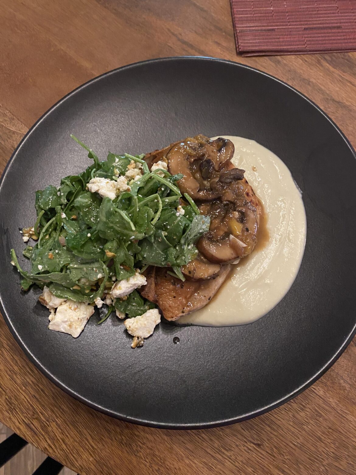 Pork sirloin chop over sweet potato purée with a mushroom peach glaze and arugula salad