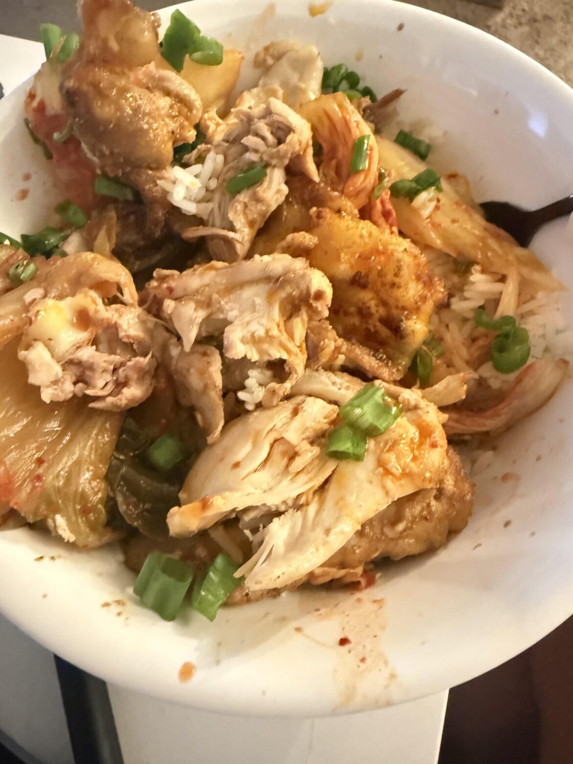 Spicy chicken, spicy kimchi, and some hot sauce over rice.