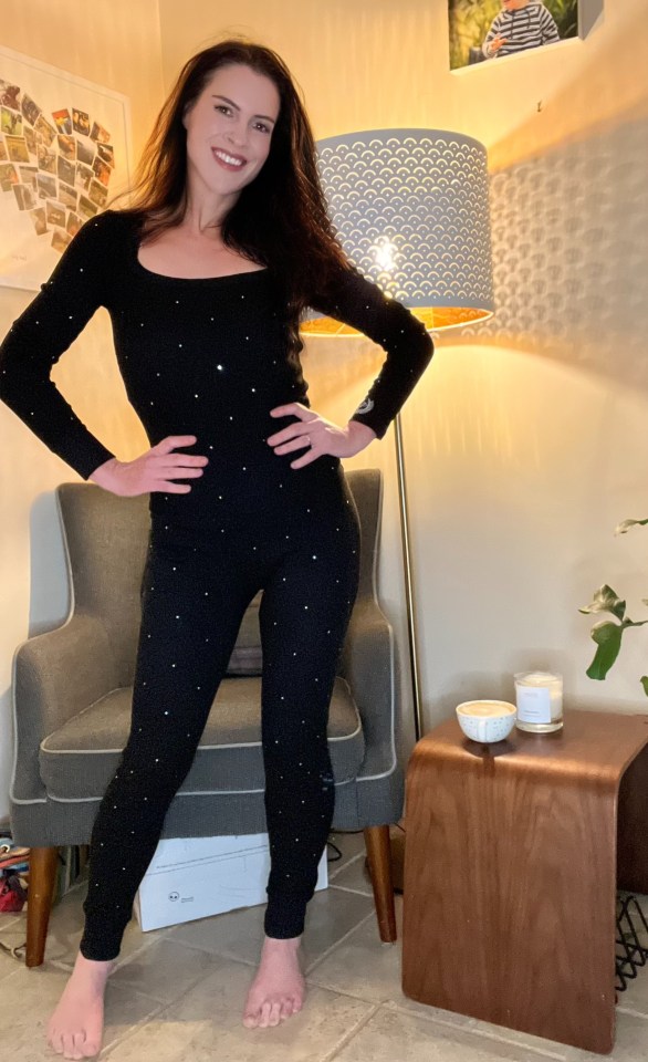 Woman in black sparkly pants and long-sleeved top.