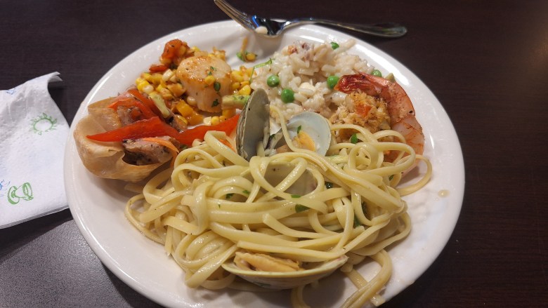 Cooking class creations: sesame-crusted tuna wanton cups, pan-seared scallops with fried corn salsa, lobster and peas risotto, crab-stuffed shrimp, and linguine with clams.