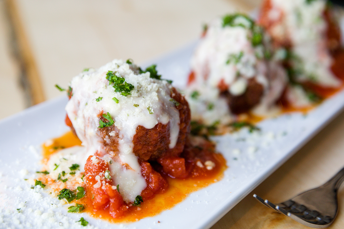 Closeup of the Crawfish Meatball. A satisfying starter that marries crawfish and crabmeat with an Italian-style red sauce.