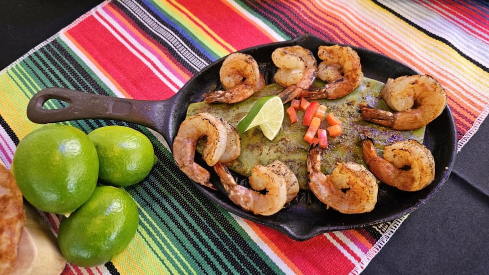An appetizer at Tacos Chisco includes grilled nopal with grilled shrimp, garnished with...