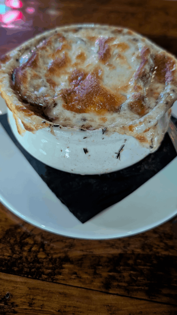 Delicious French Onion Soup At A Bar