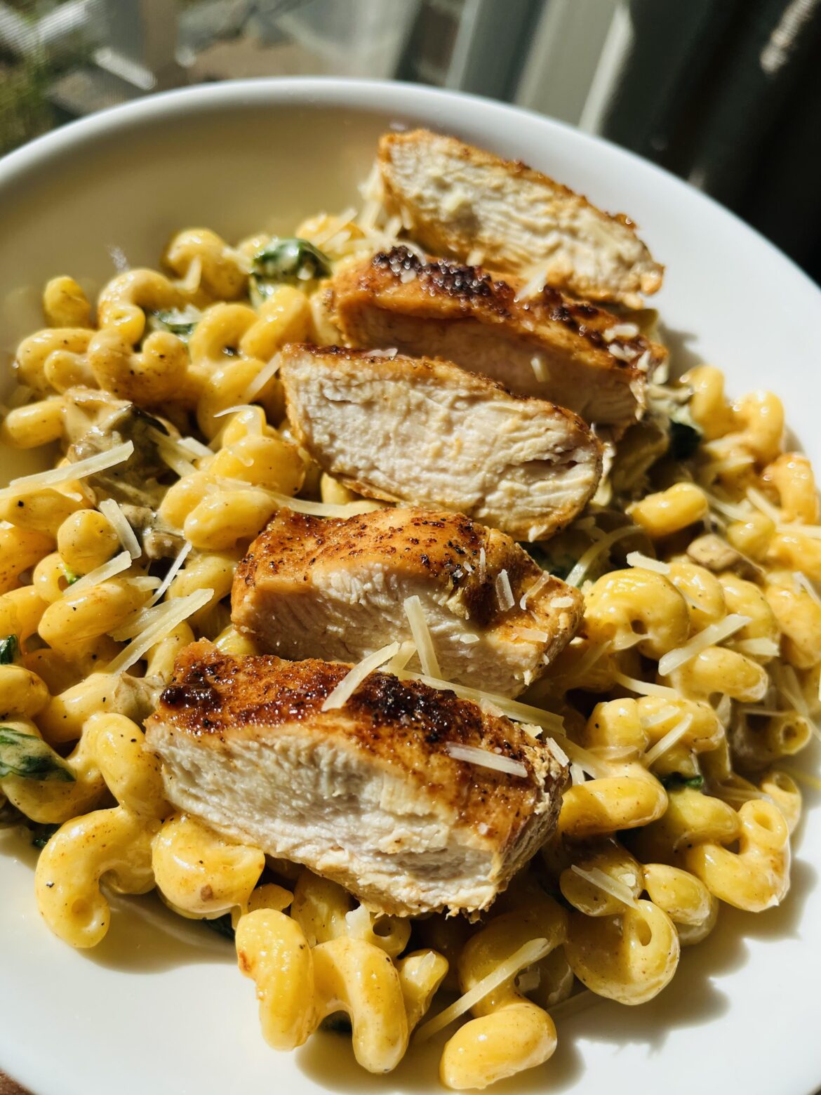 Cajun creamy Cavatappi Pasta with grilled chicken spinach and mushrooms