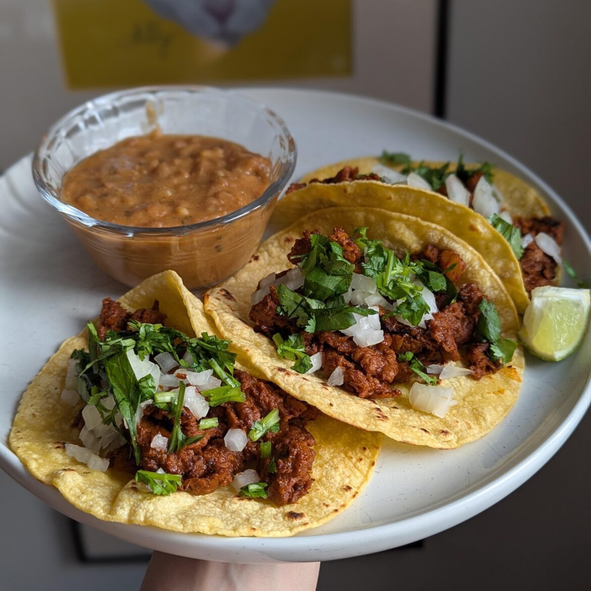 barbacoa tacos with refried beans.
