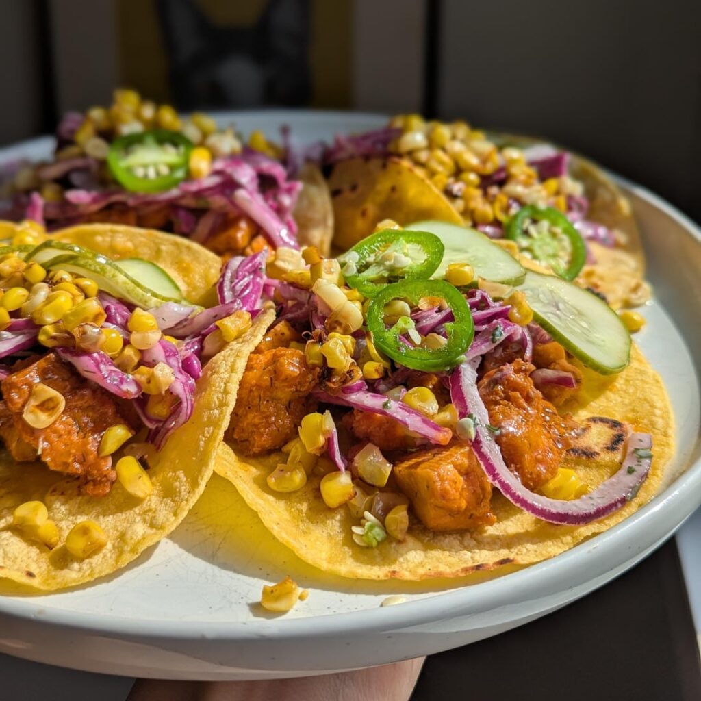 buffalo chicken tacos with ranchy slaw, roasted sweet corn, and garden-fresh quickles + jalapenos.