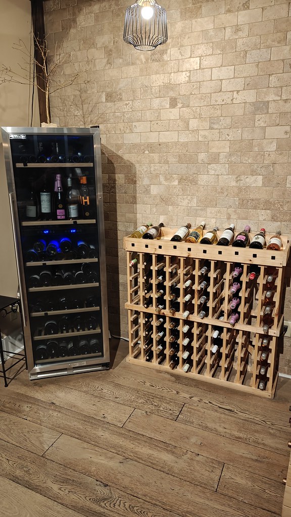 A rack and cooler of wine bottles.