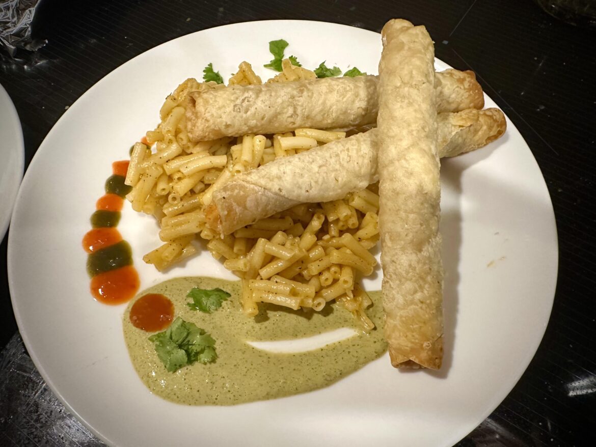 Frozen taquitos over box mac n cheese with cilantro sour cream and hot sauce