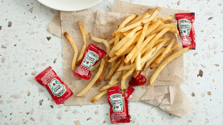 Heinz ketchup packets with fries and burger