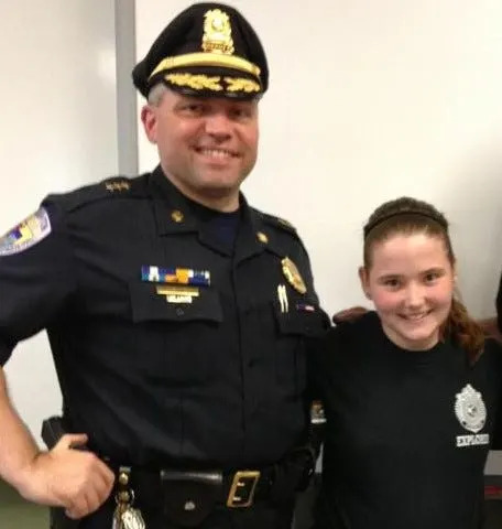 Sandra Birchmore, right, is pictured with then-Deputy Police Chief Robert Devine, one of three officers accused of having inappropriate relationships with her, when she was a member of the Stoughton Police Explorers Program as a teenager. Another former Stoughton officer, Matthew Farwell, is accused of murdering Birchmore to coverup his relationship with her when she was minor.