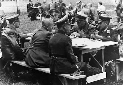 Adolf Hitler (left) and Benito Mussolini (seated next to him) eat with German officials in the Italian town of Salò, in an undated image.