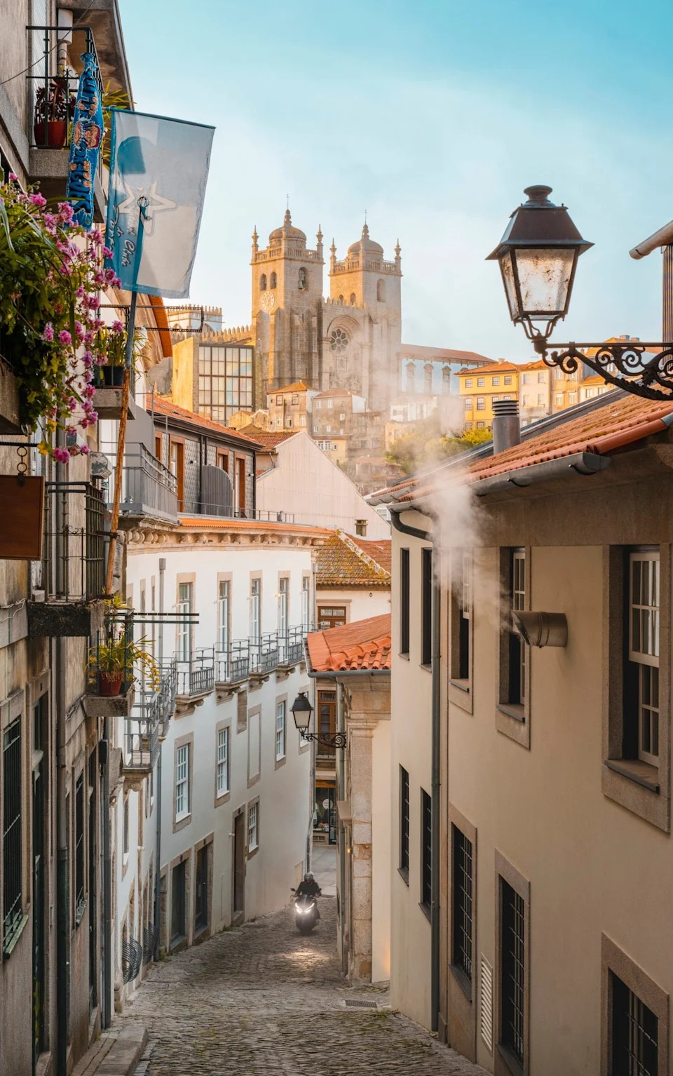 Motorbike driving on steep street in the old town of Porto, Portugal