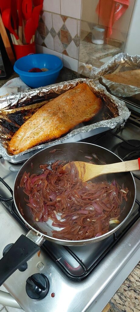 Some red onions with soy sauce and salmon.