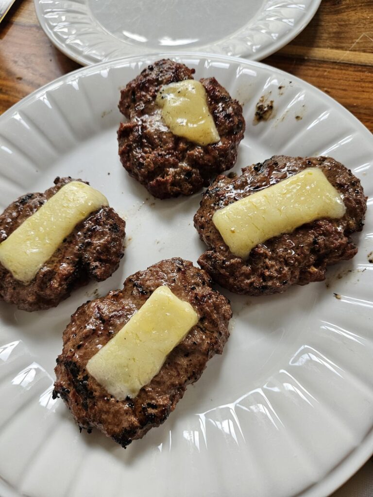 Smash burgers on propane BBQ with 5 year aged cheddar