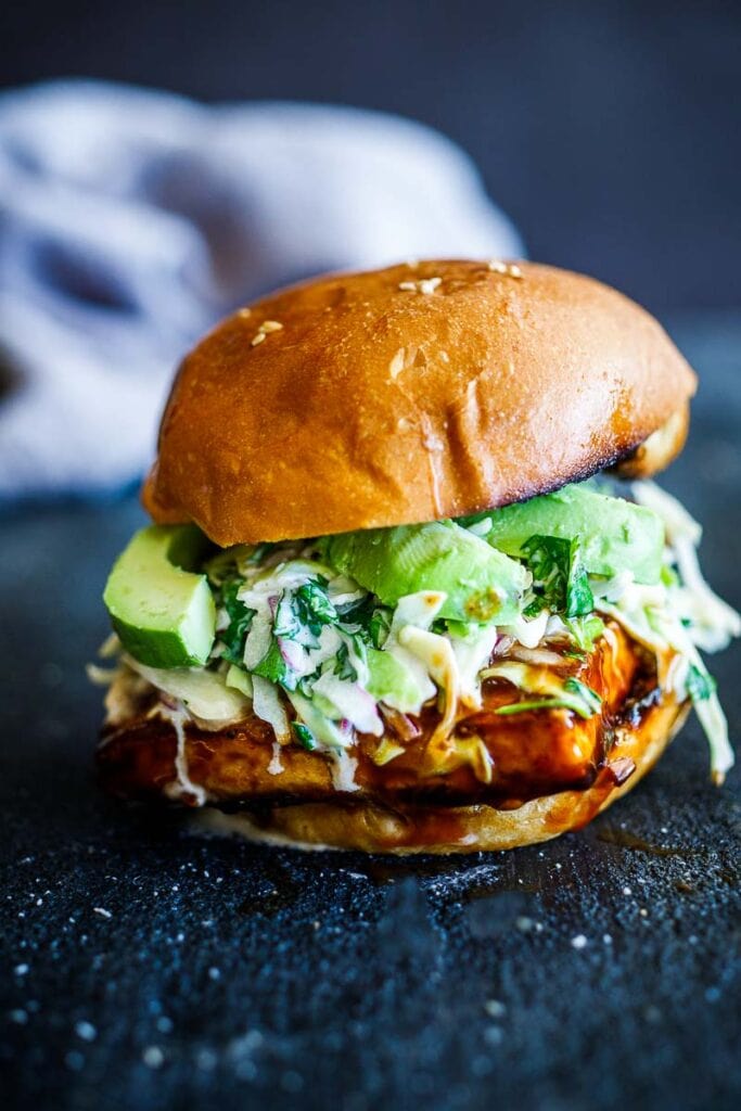 Crispy BBQ tofu sandwich with avocado and slaw. 