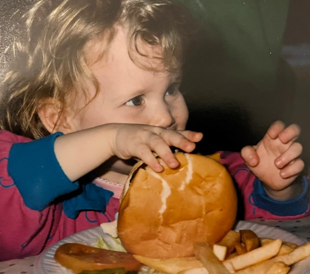 Bailey Sullivan, executive chef at Monteverde, eating a burger as a child at Goldyburger's, the restaurant her father Mike Sullivan has run since 1981. (Diane Sullivan)