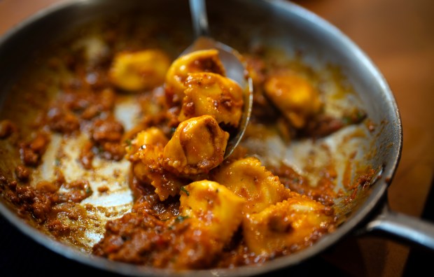 Executive chef Bailey Sullivan makes salumi sauce agnolotti filled with...