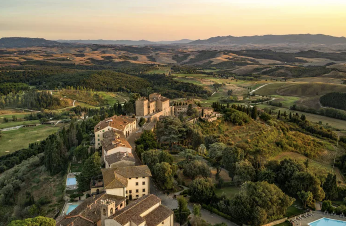 Image of a view of Castelfalfi's massive property from above, which includes 57 acres of vineyards, a castle, and 9000 olive trees.