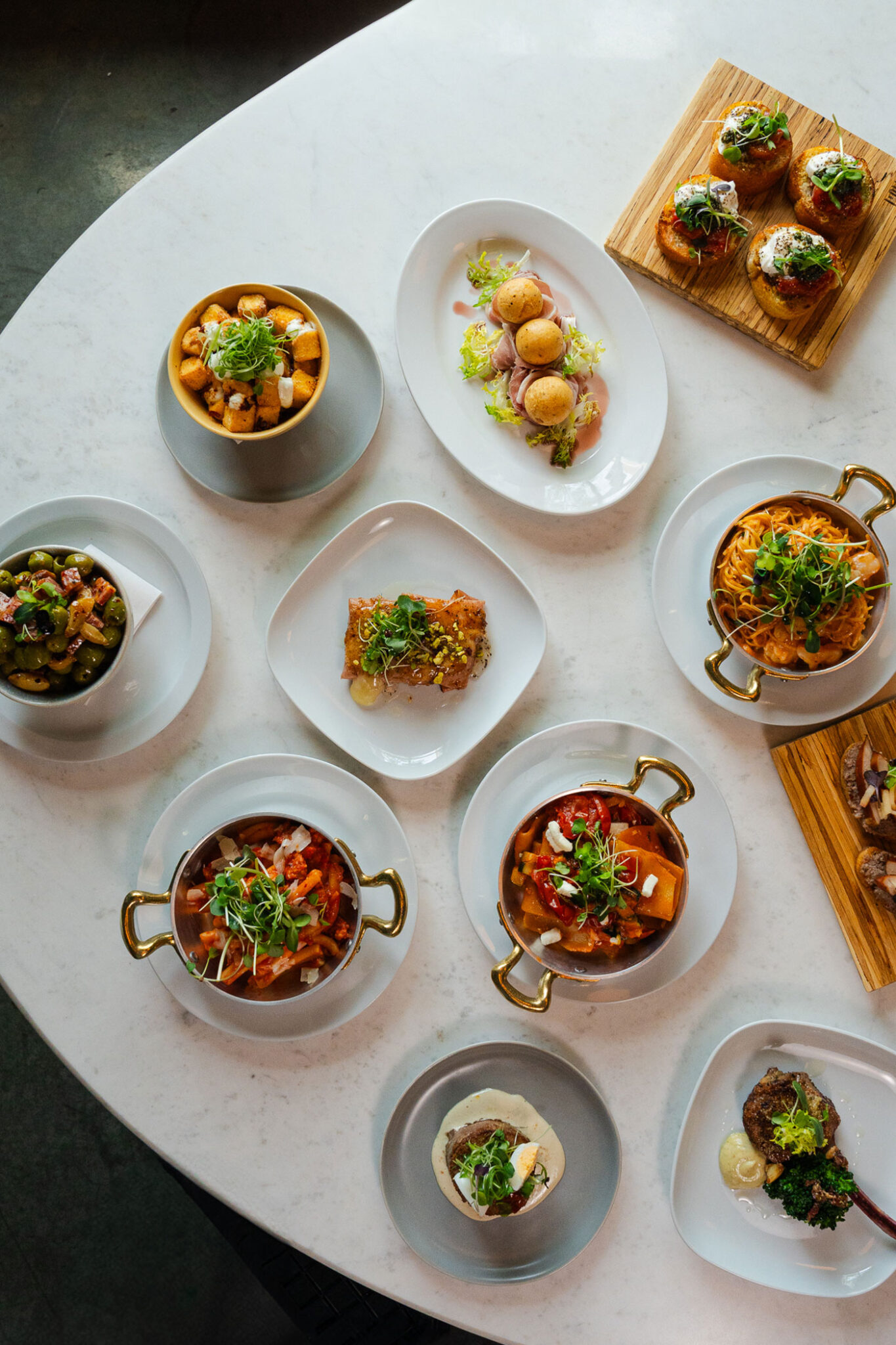 A variety of Italian dishes sit on a table.