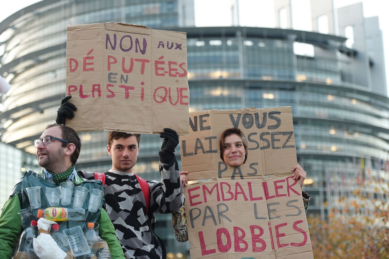 A group of young protesters hold signs with words in french