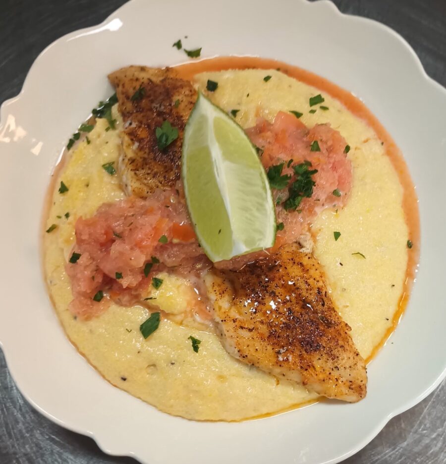 a plate of food with a lime on top of it
