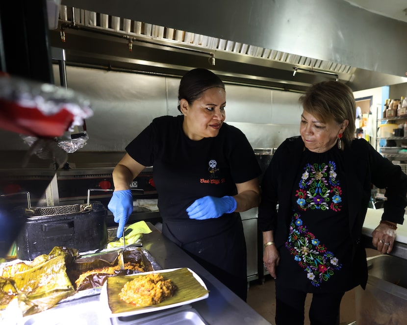 Anselma Betancourt, owner of El Catrin restaurant, right, works with staff member Jenny...