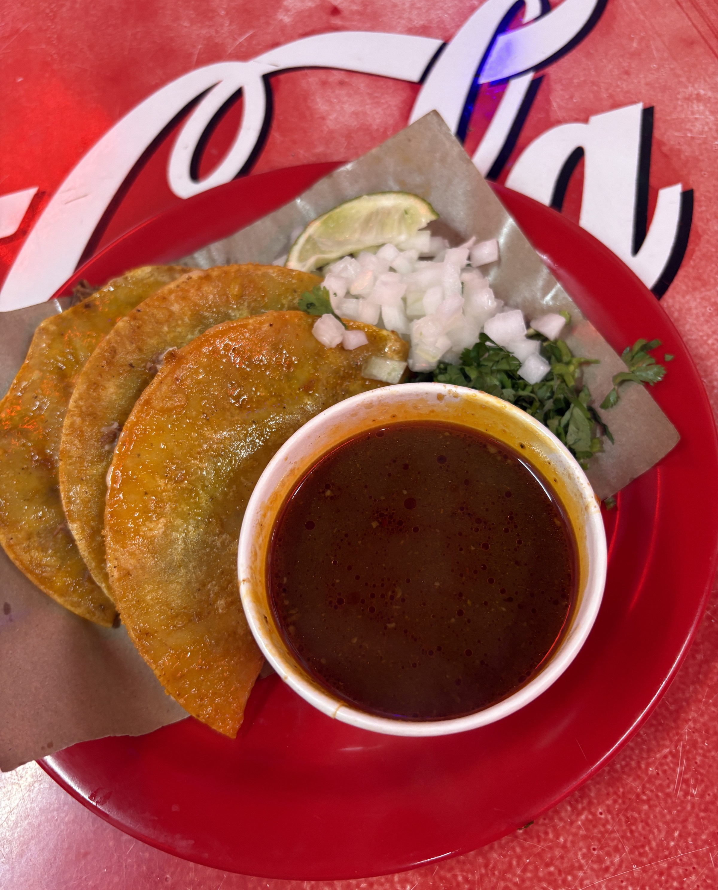 A plate of birria with consumé.