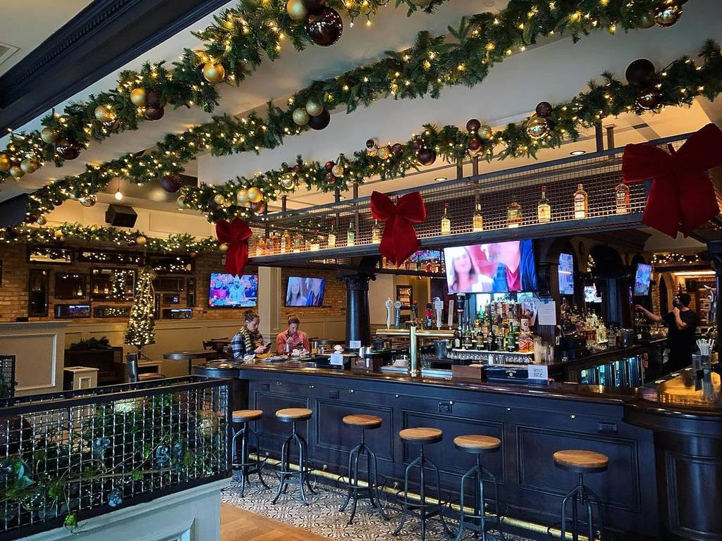 interior of LG's with Christmas lights and TVs