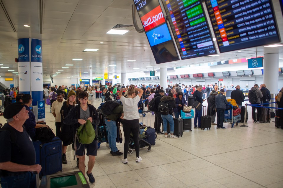 Passengers waiting in line at a Glasgow airport terminal.