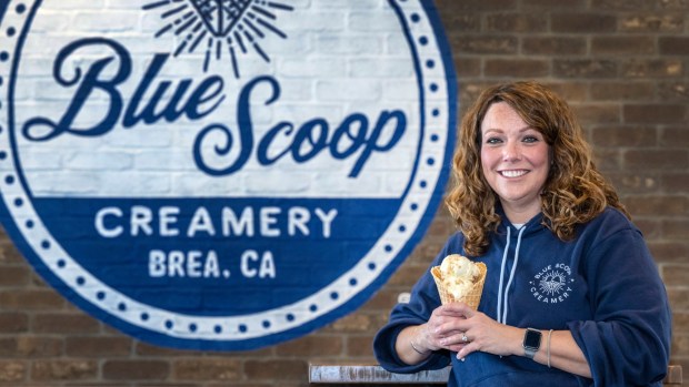 Kim Rhodes, co-owner of Blue Scoop Creamery in Brea, holds a waffle cone with honey almond brittle ice cream, on Thursday, January 25, 2025. It is the second location of the company. (Photo by Mark Rightmire, Orange County Register/SCNG)