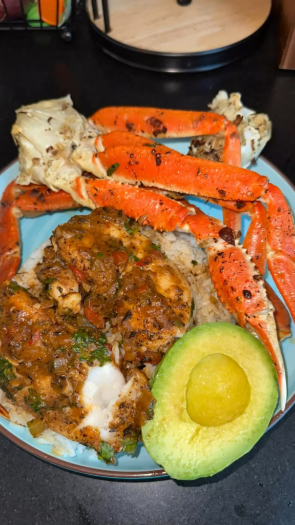 Coconut Chilean sea bass, garlic butter crab legs, Jazmine rice and avocado.