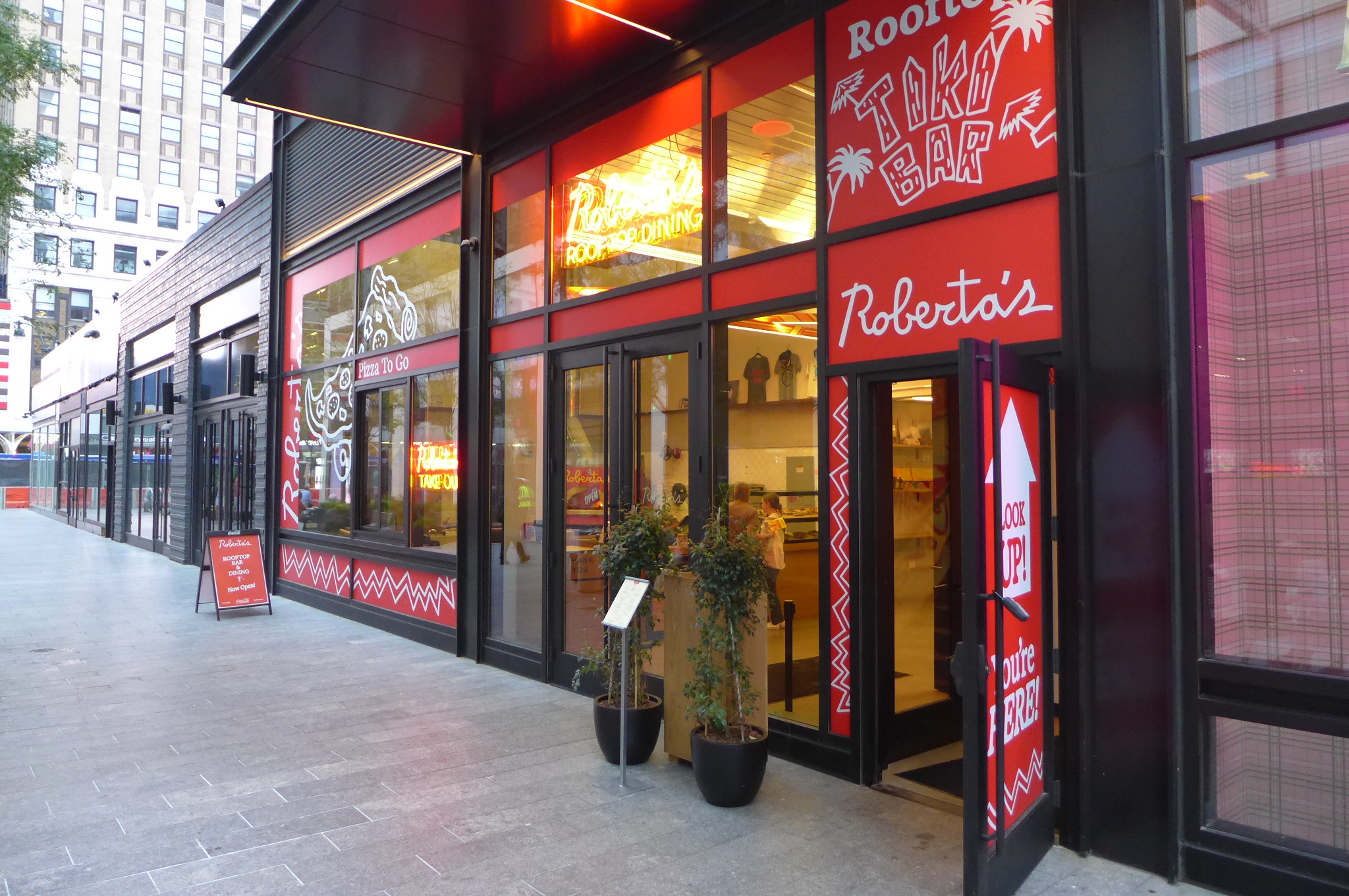 A facade covered with red signage.