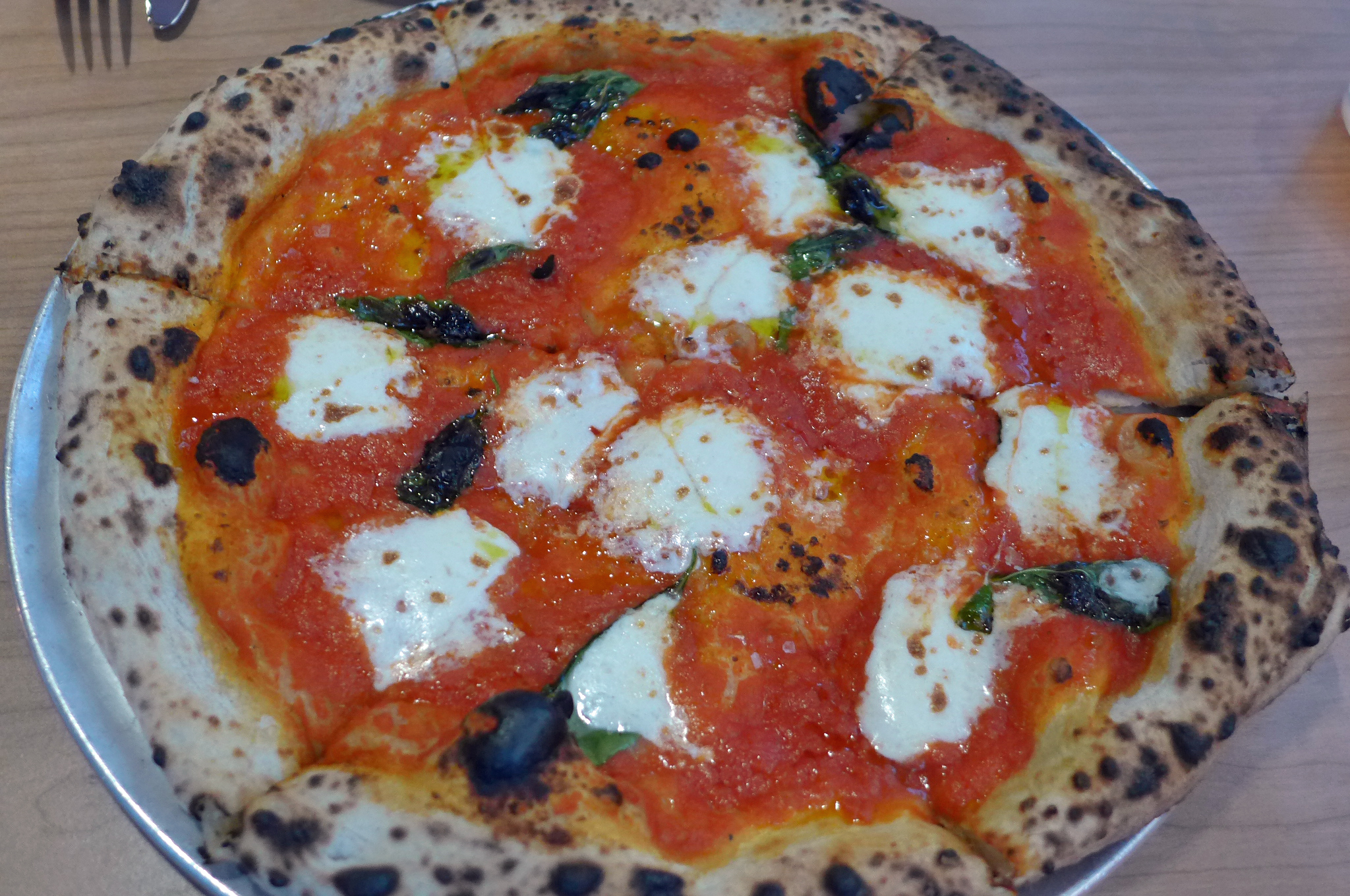 A pizza with tomato sauce and blobs of mozzarella.