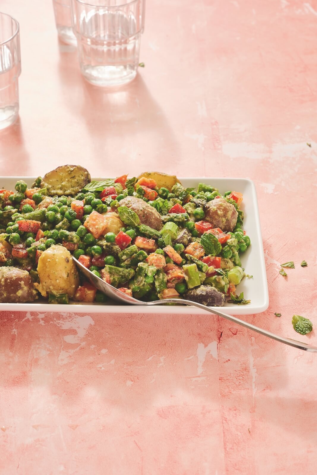 Spring asparagus and pea salad on pink table