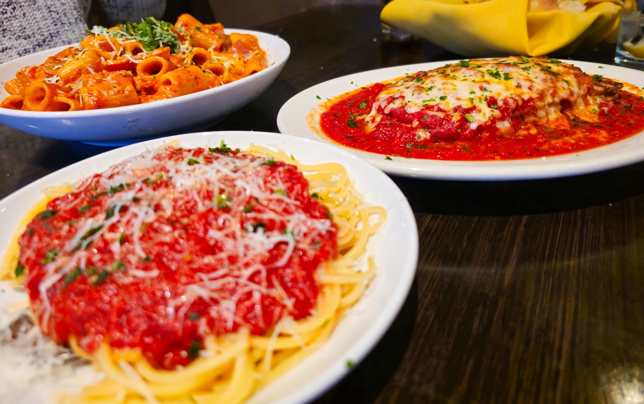 Chicken vodka riggies (back left) eggplant parmesan (back right) and a side of spaghetti from Avicolli's Restaurant in Liverpool.