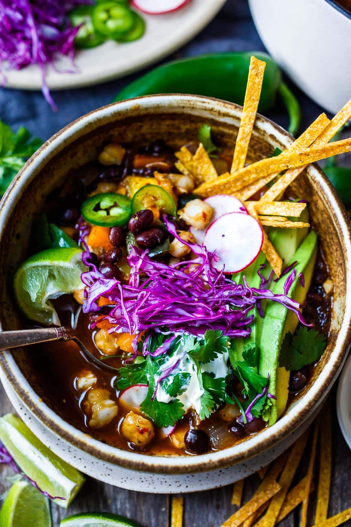 Vegan pozole in a bowl with toppings. 