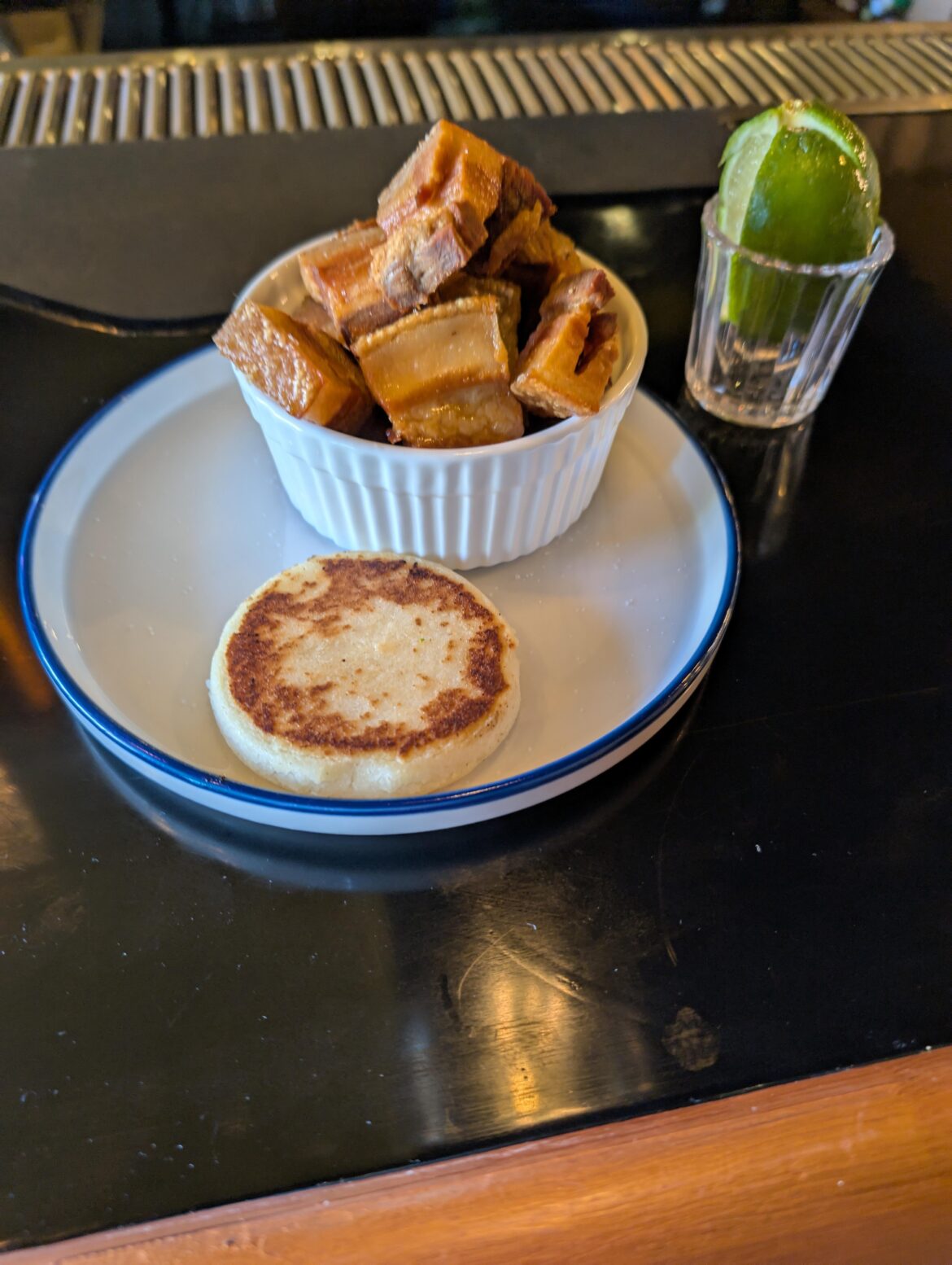 La Parrilla in Edgewater is fantastic! I got the chicharrón con arepa, arroz con pollo, and the manquesa(?)