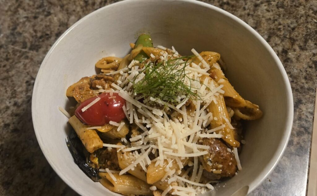 Penne Trapanese with roasted summer vegetables and Italian sausage.